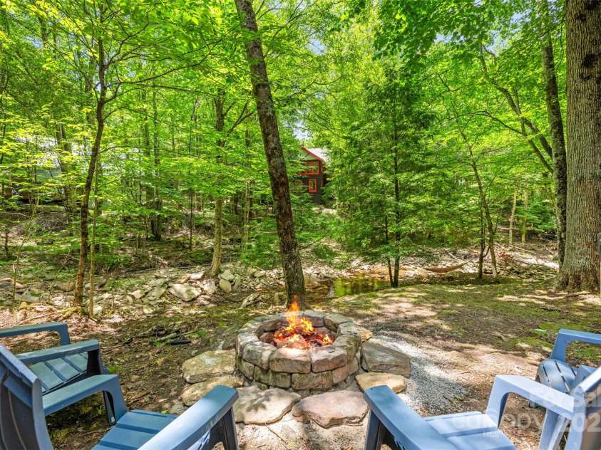 321 Charter Hills Road, Beech Mountain, NC 28604.  MLS# CAR4276469, YatesRealty ID 29495. Fire pit overlooking creek