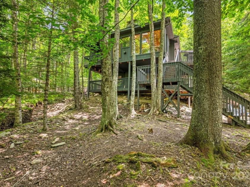 321 Charter Hills Road, Beech Mountain, NC 28604.  MLS# CAR4276469, YatesRealty ID 29495. Home from creek/ view of yard