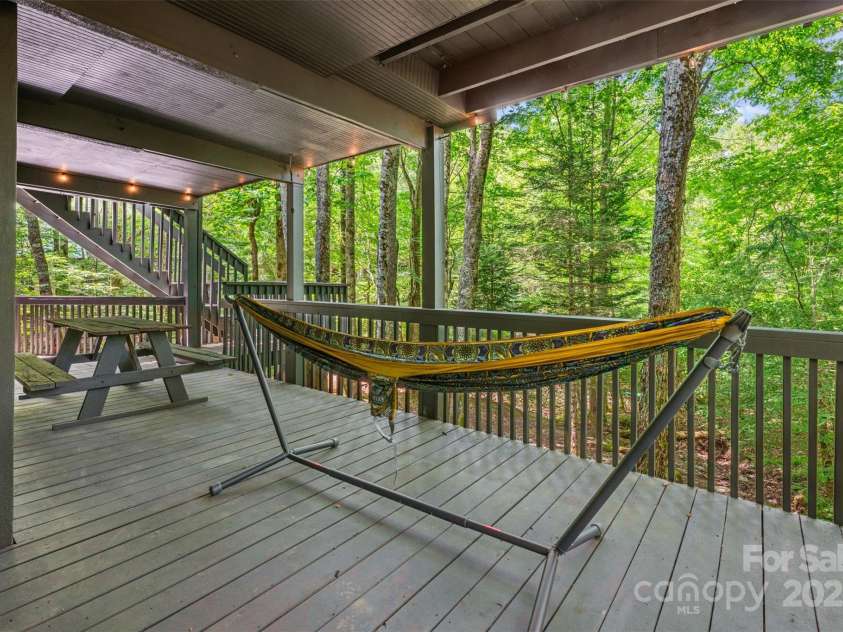 321 Charter Hills Road, Beech Mountain, NC 28604.  MLS# CAR4276469, YatesRealty ID 29495. Lower covered porch overlooking creek