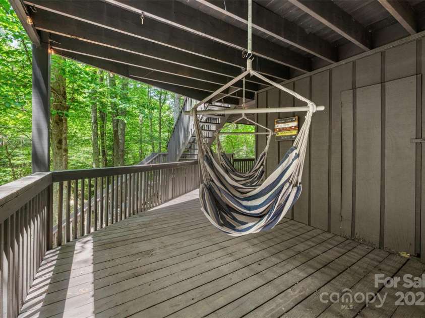 321 Charter Hills Road, Beech Mountain, NC 28604.  MLS# CAR4276469, YatesRealty ID 29495. Lower covered porch overlooking creek