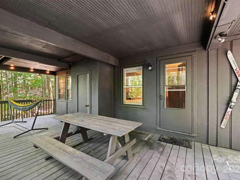 321 Charter Hills Road, Beech Mountain, NC 28604.  MLS# CAR4276469, YatesRealty ID 29495. Lower porch overlooking creek