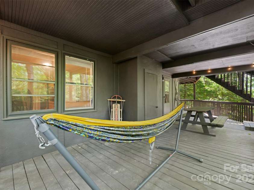 321 Charter Hills Road, Beech Mountain, NC 28604.  MLS# CAR4276469, YatesRealty ID 29495. Lower porch overlooking creek
