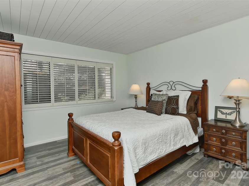 51 Old Post Road, Lake Wylie, SC 29710.  MLS# CAR4207674, YatesRealty ID 2950. Big main level bedroom w/vinyl plank flooring, wood ceilings and plantation shutters.