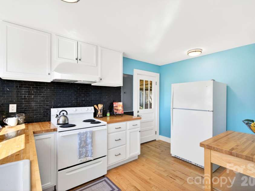 440 Carolina Avenue, Brevard, NC 28712.  MLS# CAR4390978, YatesRealty ID 29504. Kitchen with Black Tile Backsplash