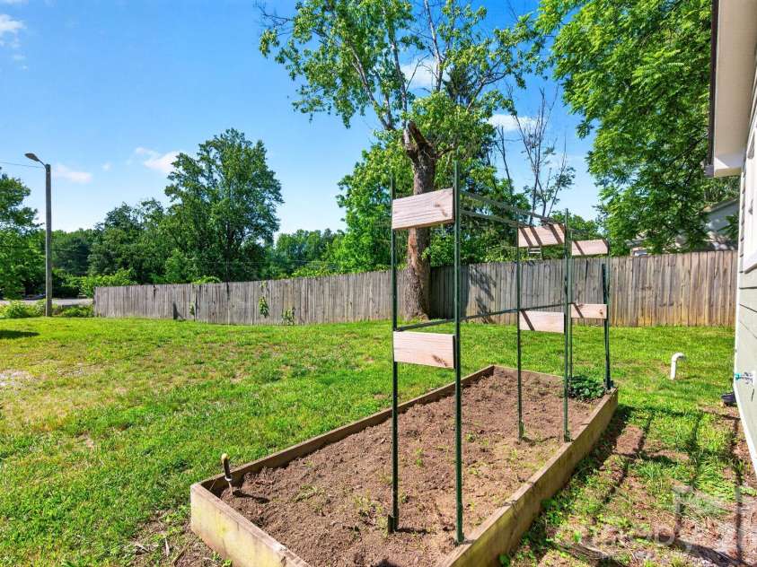 440 Carolina Avenue, Brevard, NC 28712.  MLS# CAR4390978, YatesRealty ID 29504. Raised Garden Bed and Side Yard