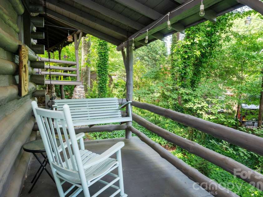 15 and 16 Cottage Drive, Asheville, NC 28805.  MLS# CAR4392051, YatesRealty ID 29512. 16 Cottage Dr Back Deck Surrounded by Greenery