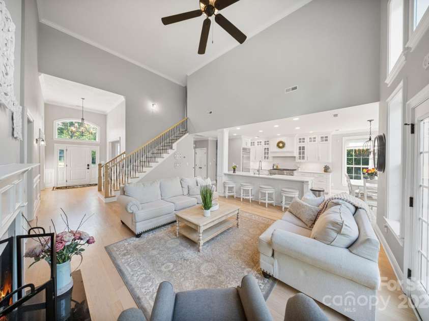 4660 Sugar Plum Lane, Davidson, NC 28036.  MLS# CAR4273062, YatesRealty ID 29516. Great Rm open to Kitchen and Breakfast Rm w/wood burning fireplace, built-ins and wall-of-windows and French door opening to deck.