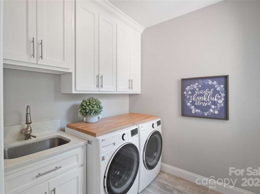 4660 Sugar Plum Lane, Davidson, NC 28036.  MLS# CAR4273062, YatesRealty ID 29516. Main Floor Laundry Rm w/cabinets. sink and folding area.
