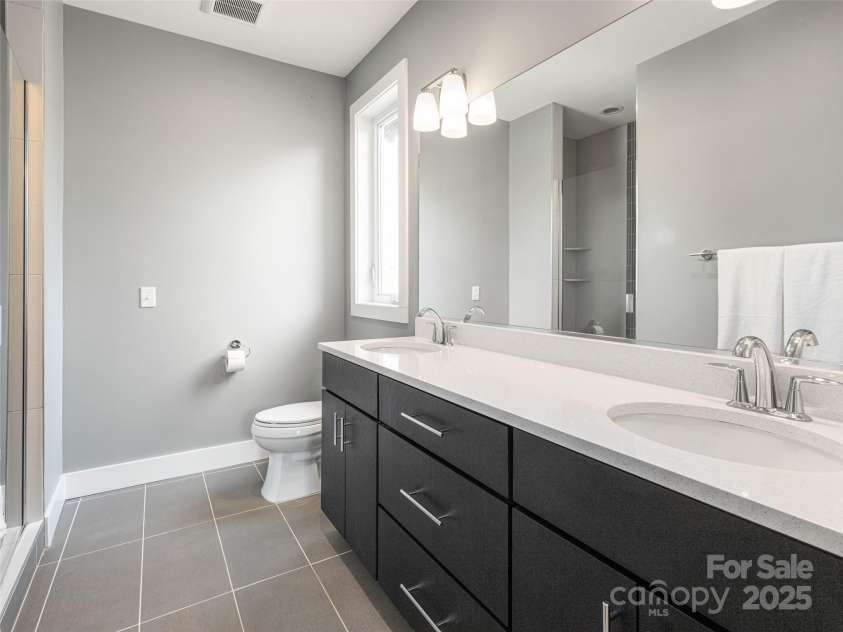 7 Mauricet Lane, Asheville, NC 28806.  MLS# CAR4241872, YatesRealty ID 2952. Primary bath with double vanities 