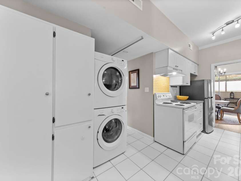 5941 Quail Hollow Road, Charlotte, NC 28210.  MLS# CAR4391742, YatesRealty ID 29529. Laundry and additional storage in kitchen.