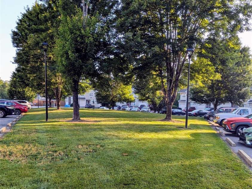 65 Foxden Drive, Fletcher, NC 28732.  MLS# CAR4389530, YatesRealty ID 29552. Green area across from unit