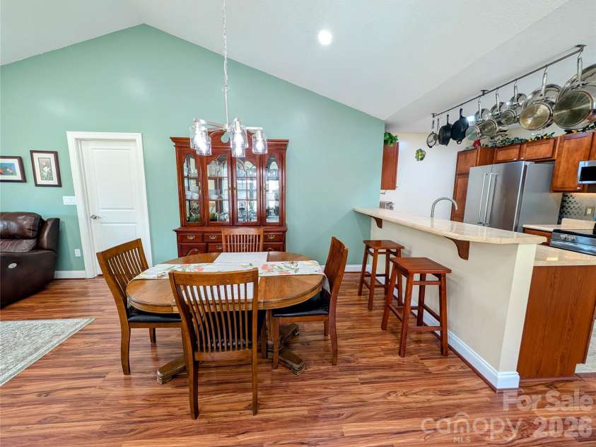 65 Foxden Drive, Fletcher, NC 28732.  MLS# CAR4389530, YatesRealty ID 29552. Large dining area with new chandelier