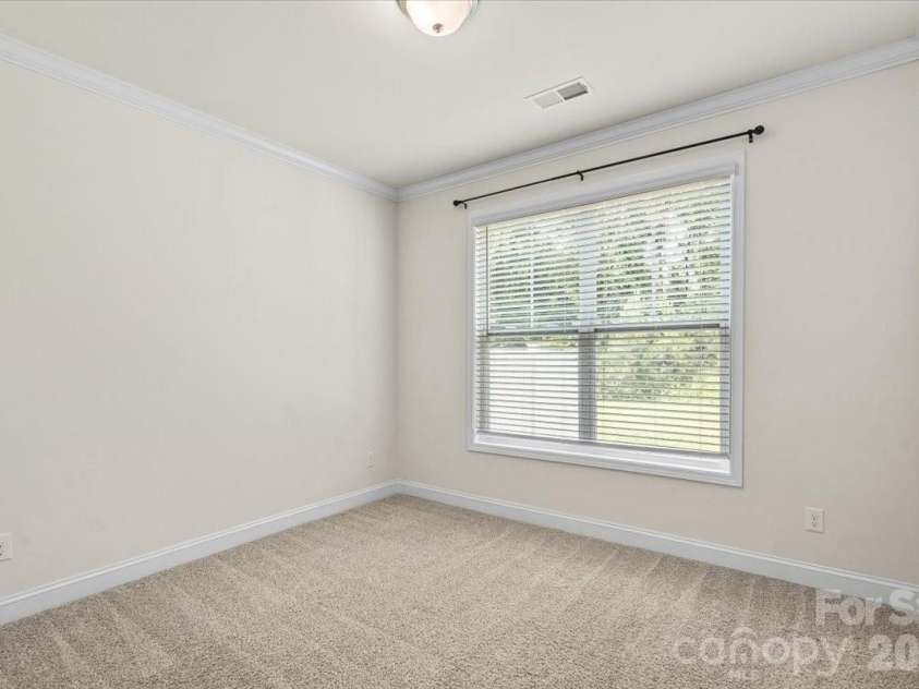 6040 Artigas Drive, Fort Mill, SC 29707.  MLS# CAR4390680, YatesRealty ID 29555. Main level bedroom