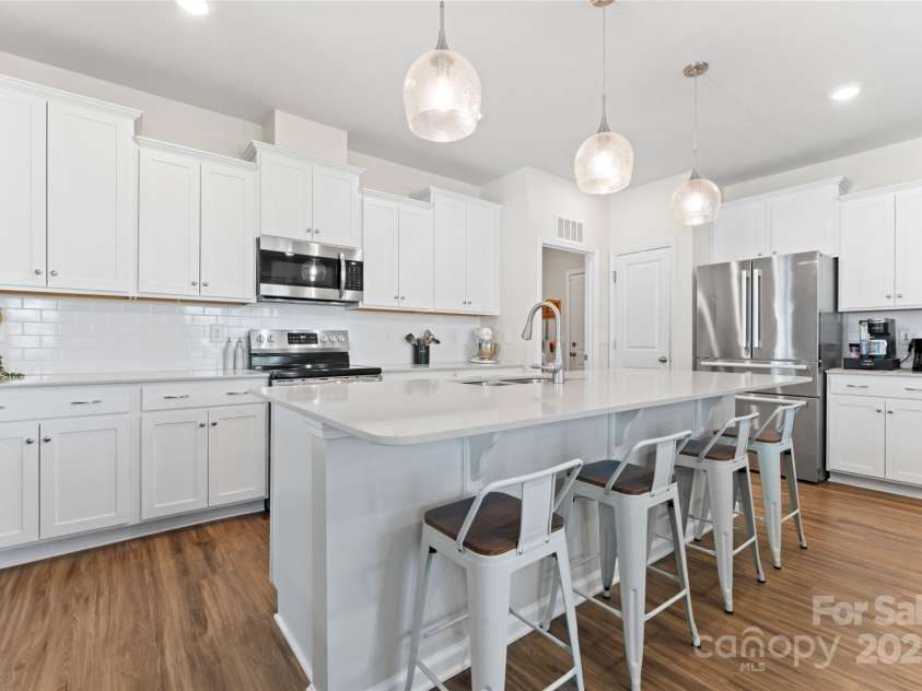 7742 Sea Turtle Way, Lancaster, SC 29720.  MLS# CAR4285392, YatesRealty ID 29562. White kitchen with stainless steel appliances