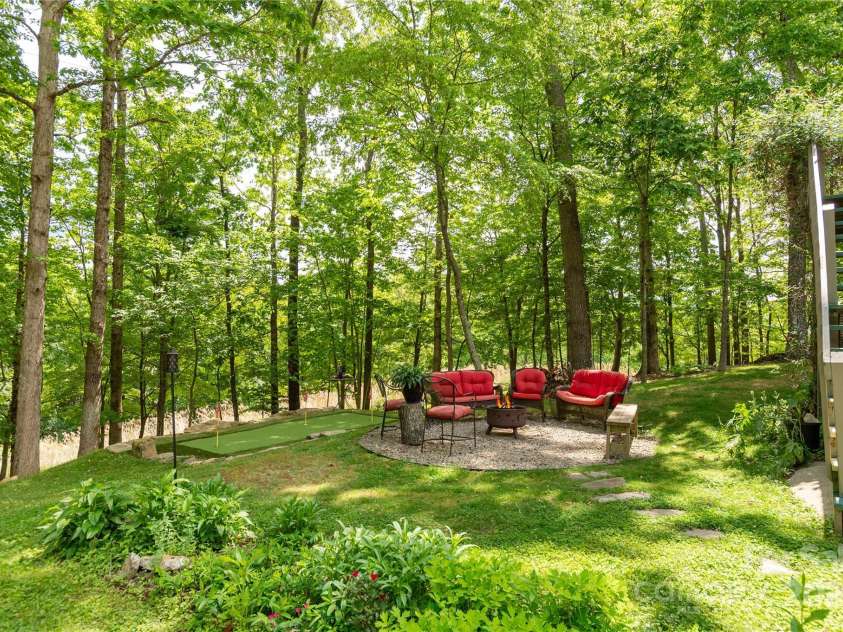 230 Foxwood Drive, Hendersonville, NC 28791.  MLS# CAR4255865, YatesRealty ID 29566. Fire pit area with putting green