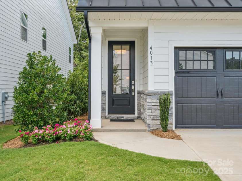 4013 Easton Ridge Lane, Charlotte, NC 28226.  MLS# CAR4264310, YatesRealty ID 29567. New professional designed landscaping on the side yard with spigot fed battery operated dripline system.