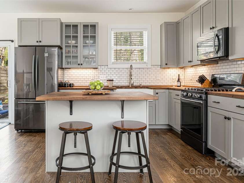 704 Azalea Avenue, Black Mountain, NC 28711.  MLS# CAR4283661, YatesRealty ID 29588. Kitchen island with storage and bar seating