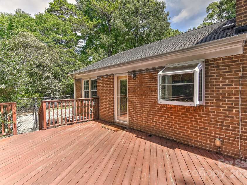 6117 Yellowood Road, Charlotte, NC 28210.  MLS# CAR4272398, YatesRealty ID 29599. Big deck off kitchen and one set of stairs lead to gate at drive way.