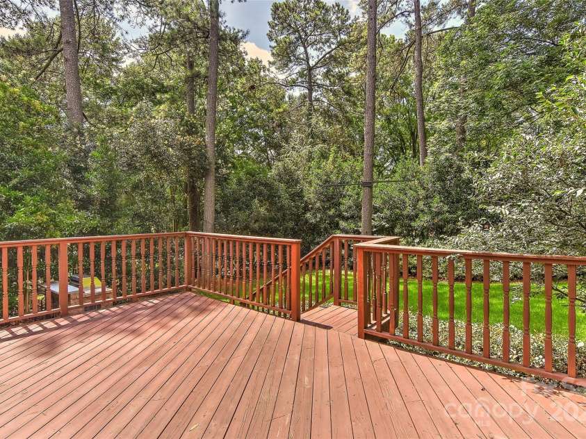 6117 Yellowood Road, Charlotte, NC 28210.  MLS# CAR4272398, YatesRealty ID 29599. Big deck two sets of stairs; one leading to patio & yard and other to drive way & yard.