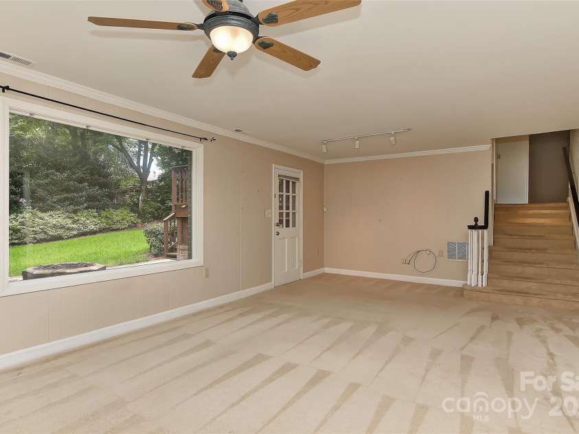 6117 Yellowood Road, Charlotte, NC 28210.  MLS# CAR4272398, YatesRealty ID 29599. Family room lower level with door leading to patio & built in gas grill.
