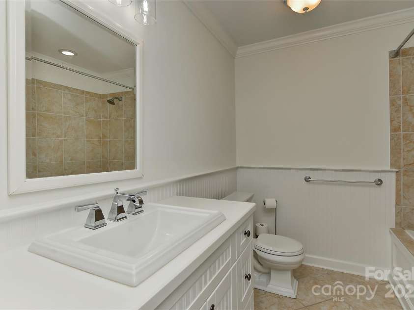 6117 Yellowood Road, Charlotte, NC 28210.  MLS# CAR4272398, YatesRealty ID 29599. Full hall bath up with  Bead board, new light over vanity with dimmer control light switch, tile flooring, deep tub & shower combo and linen closet.