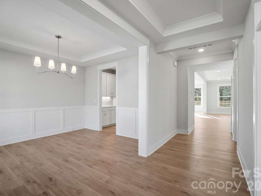 5054 McLaughlin Loop, Waxhaw, NC 28173.  MLS# CAR4329156, YatesRealty ID 29609. Dining room with Craftsman-style trim and tray ceiling