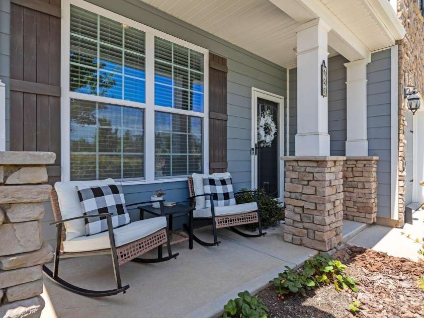 127 Atwater Landing Drive, Mooresville, NC 28117.  MLS# CAR4283079, YatesRealty ID 29629. Rocking chair front porch