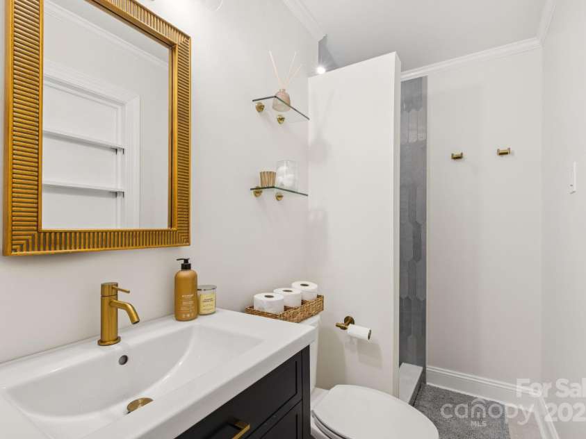 1520 Starbrook Drive, Charlotte, NC 28210.  MLS# CAR4274449, YatesRealty ID 29630. Beautiful, bright primary bathroom - check out video walkthrough to see the gorgeous floor-to-ceiling tile! Completely renovated in June 2024.