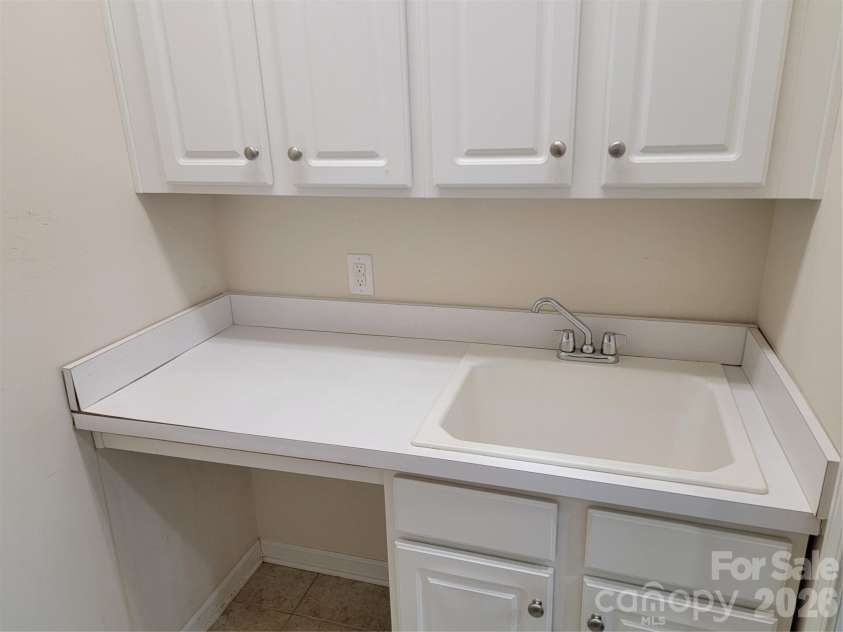 5112 Folly Lane, Fort Mill, SC 29707.  MLS# CAR4373813, YatesRealty ID 29633. Separate laundry room with cabinets