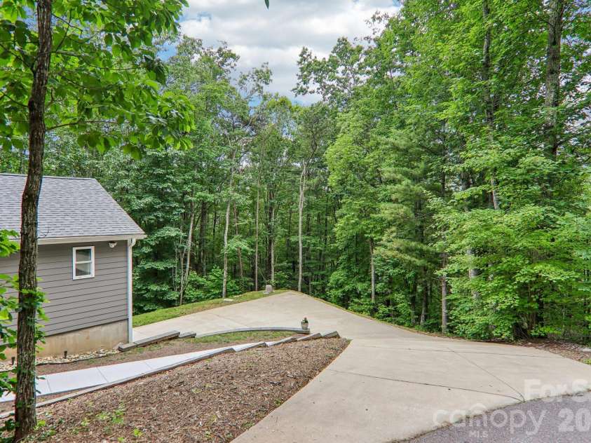 49 Wilderness Trail, Candler, NC 28715.  MLS# CAR4391801, YatesRealty ID 29657. Top of driveway is steep and goes down to level parking