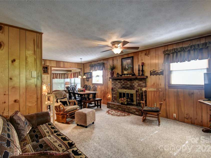 134 Raven Ridge, Maggie Valley, NC 28751.  MLS# CAR4249162, YatesRealty ID 29662. Living Area from the entry door, the rock facade fireplace is wood-burning