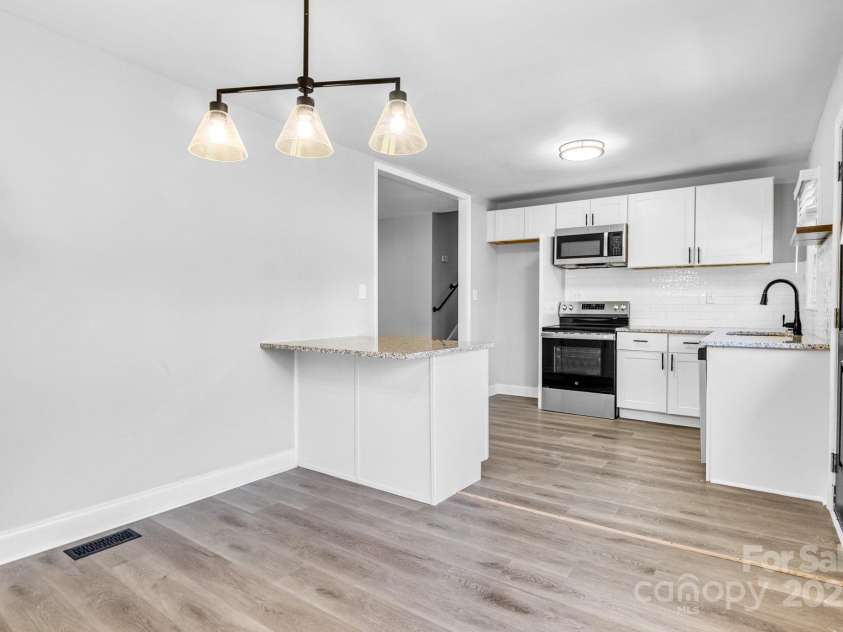609 Bilmark Avenue, Charlotte, NC 28213.  MLS# CAR4276678, YatesRealty ID 29671. Shot of kitchen from standing in dining area.