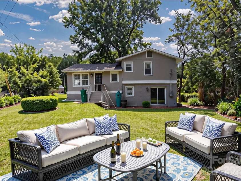 609 Bilmark Avenue, Charlotte, NC 28213.  MLS# CAR4276678, YatesRealty ID 29671. Shot of the rear of the home & backyard (virtually staged), taken standing near the fence.