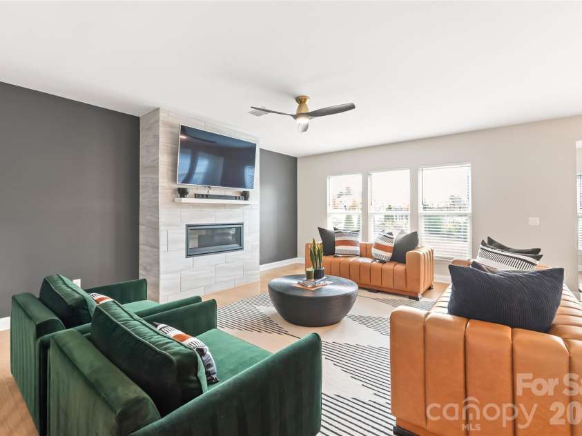 12205 Hollinhope Drive, Charlotte, NC 28278.  MLS# CAR4385321, YatesRealty ID 29673. Living Room with modern fireplace and natural light pouring into the home