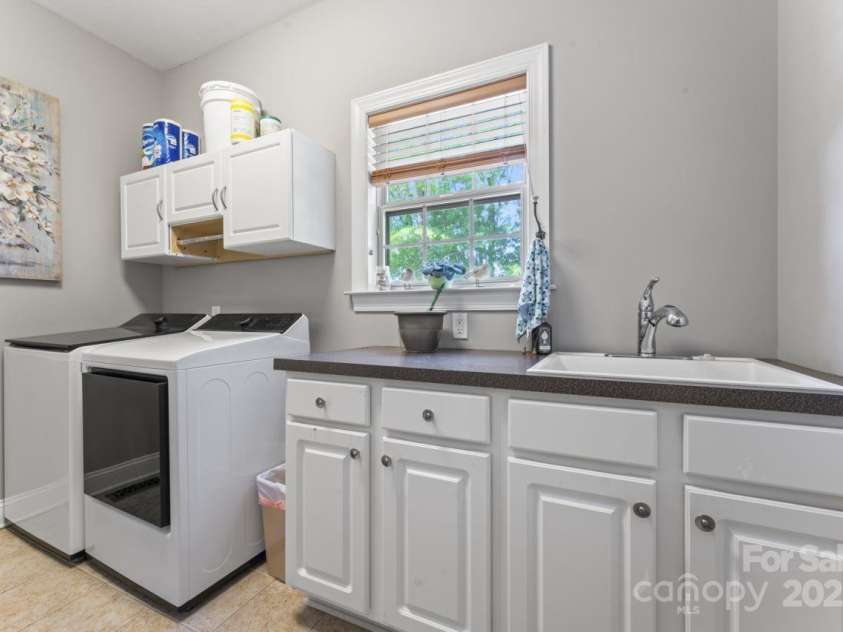 3398 Millstone Creek Road, Lancaster, SC 29720.  MLS# CAR4251065, YatesRealty ID 29678. Laundry Room with Wash Sink and plenty of cabinet Space