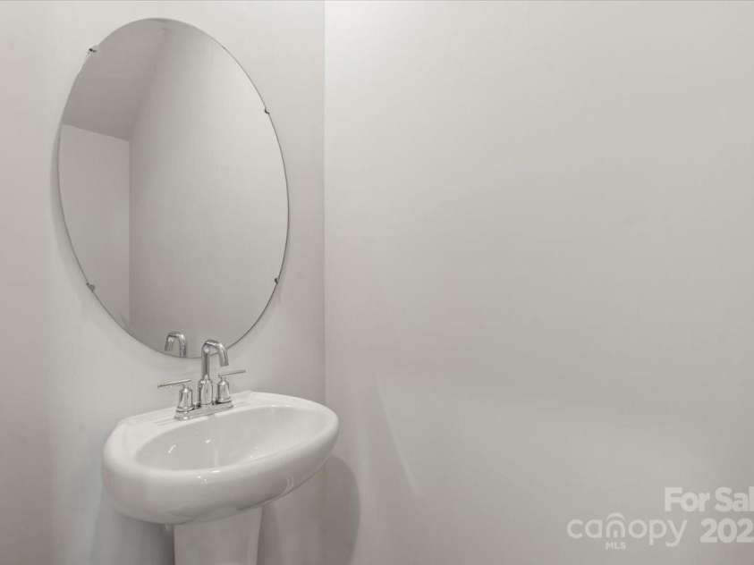 1021 Plumcrest Drive, Charlotte, NC 28216.  MLS# CAR4285638, YatesRealty ID 29689. Half bath downstairs w/pedestal sink