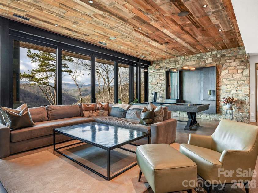 112 Moon Shadow Lane, Marshall, NC 28753.  MLS# CAR4332984, YatesRealty ID 2969. Family room on lower level with disappearing sliding doors, opening up to the lower level patio.