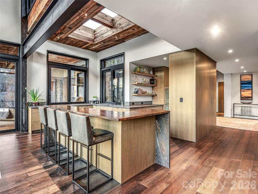 112 Moon Shadow Lane, Marshall, NC 28753.  MLS# CAR4332984, YatesRealty ID 2969. Grain-matched, quarter-sawn white oak cabinetry throughout the entire home (Hoeh Works). Leathered granite island and wet bar. (Mountain Marble)