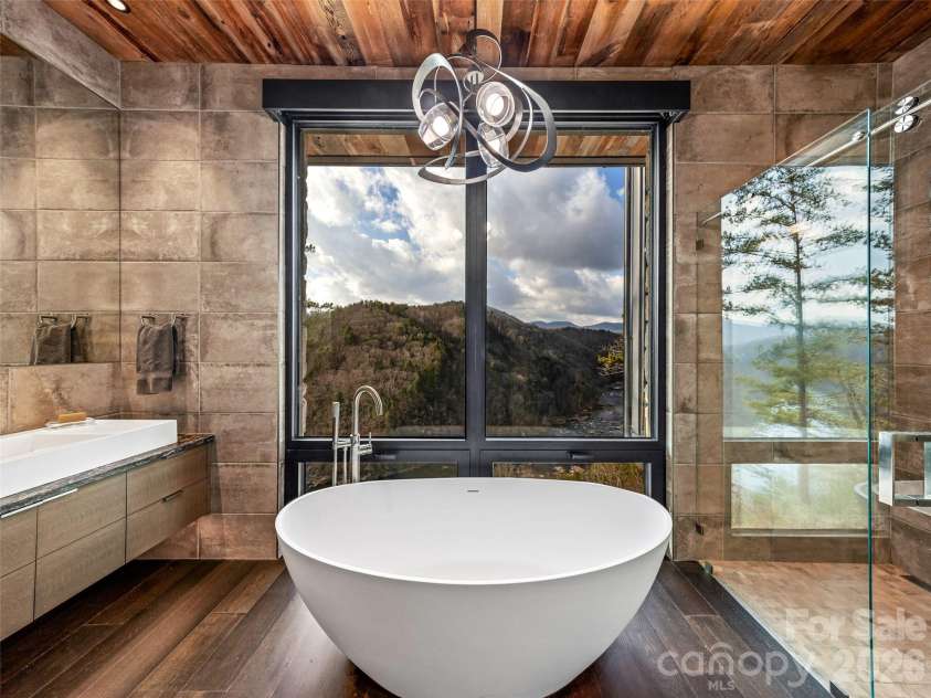 112 Moon Shadow Lane, Marshall, NC 28753.  MLS# CAR4332984, YatesRealty ID 2969. Primary bath with soaking tub and walk-in shower with views!