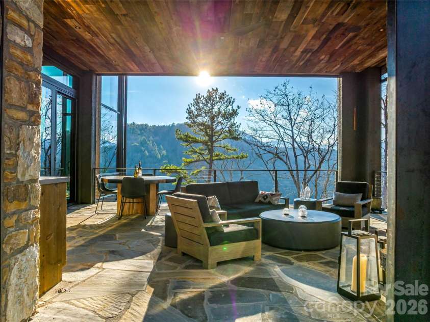 112 Moon Shadow Lane, Marshall, NC 28753.  MLS# CAR4332984, YatesRealty ID 2969. Retractable screened porch with fireplace and built in grill makes outdoor living a breeze.