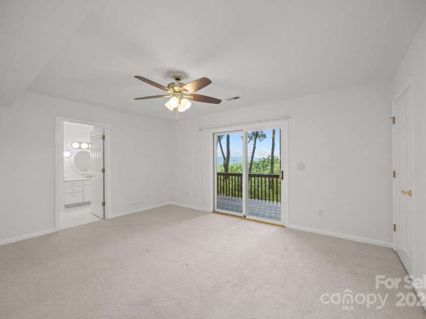 110 Thrashing Rock Drive, Hendersonville, NC 28739.  MLS# CAR4282429, YatesRealty ID 29693. Downstairs bedroom with access to deck and ensuite bathroom