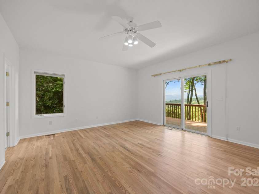 110 Thrashing Rock Drive, Hendersonville, NC 28739.  MLS# CAR4282429, YatesRealty ID 29693. Primary bedroom with views and access to deck