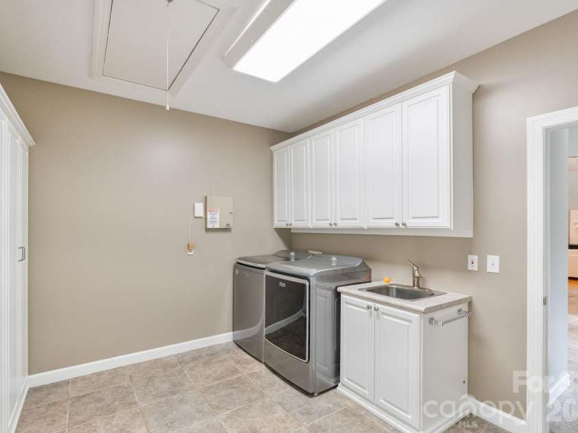 182 Broadview Circle, Mooresville, NC 28117.  MLS# CAR4352412, YatesRealty ID 29701. Main level laundry includes sink and ample storage