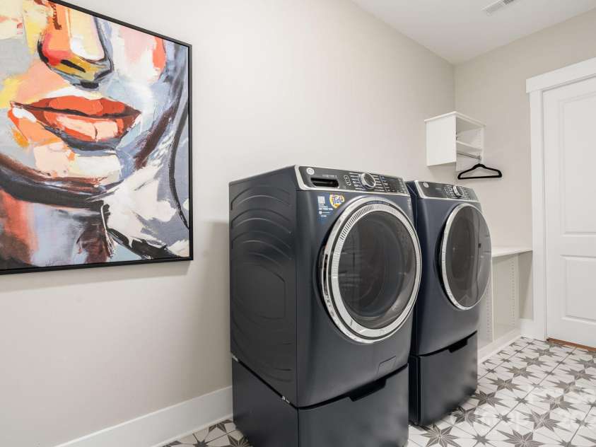 21016 Molly Harper Drive, Cornelius, NC 28031.  MLS# CAR4320388, YatesRealty ID 29705. Large laundry room with closet for tech and tools as well as hanging rods and folding space