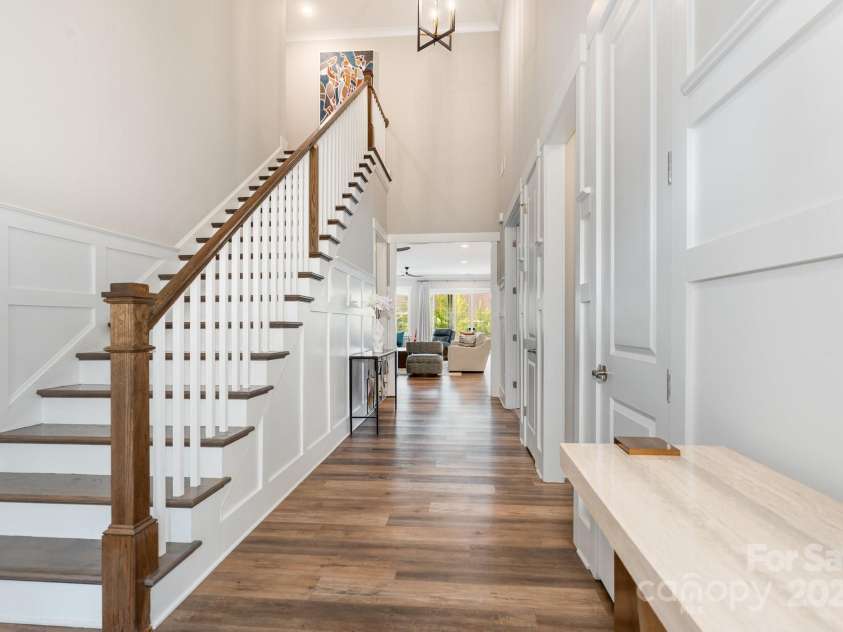 21016 Molly Harper Drive, Cornelius, NC 28031.  MLS# CAR4320388, YatesRealty ID 29705. Stunning entryway with grand staircase with fabulous wainscot and crown molding.