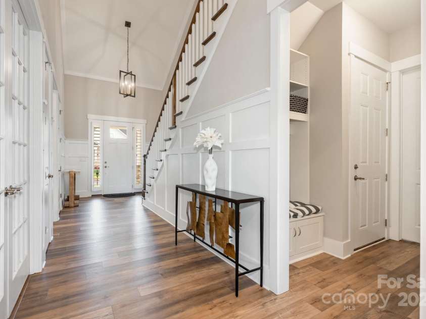 21016 Molly Harper Drive, Cornelius, NC 28031.  MLS# CAR4320388, YatesRealty ID 29705. The front of the home features a guest suite and office with glass french doors and full bath. Or, step in from the garage to a tucked away drop zone