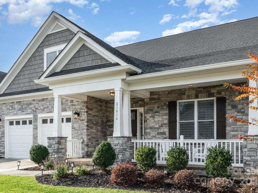 21016 Molly Harper Drive, Cornelius, NC 28031.  MLS# CAR4320388, YatesRealty ID 29705. The stonework and landscaping accentuate the color palette of this home