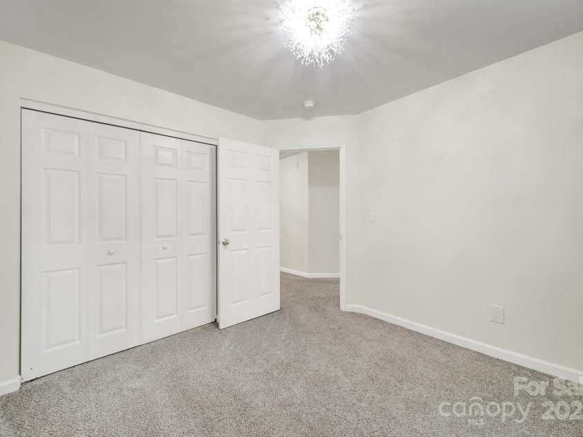 7801 Bella Vista Court, Charlotte, NC 28216.  MLS# CAR4285247, YatesRealty ID 29767. Another view of Bedroom 3 leading to the hallway.
