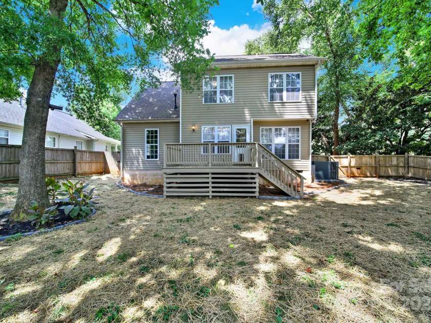 7801 Bella Vista Court, Charlotte, NC 28216.  MLS# CAR4285247, YatesRealty ID 29767. Another view of the back of the home and yard showing mature landscaping and NEW deck.