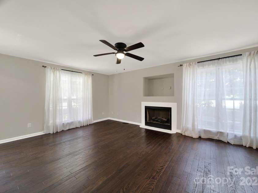 7801 Bella Vista Court, Charlotte, NC 28216.  MLS# CAR4285247, YatesRealty ID 29767. Another view of the Family Room showing the warm hardwoods and neutral paint.